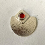 White metal pendant with texture and layers with Carnelian stone